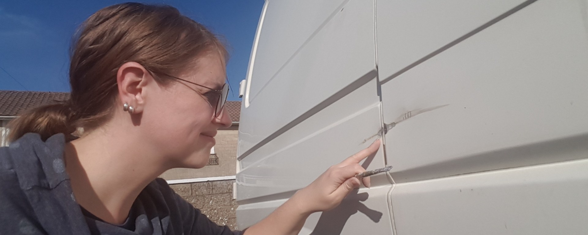 Examining a big scratch in my van