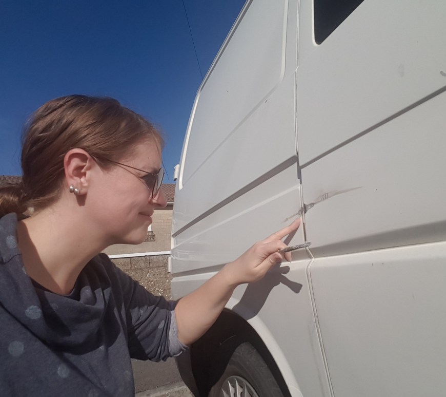 Examining a big scratch in my van
